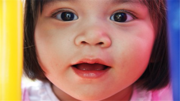 Close picture of a young girl's face smiling at the camera